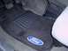 1992 Ford Bronco - Close-up of the driver's side floor area showing the pedals and a Ford-branded floor mat.