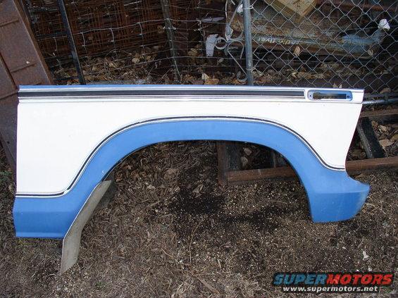 white and blue vehicle fender with black trim