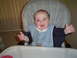 1981 Ford Bronco - A baby sits in a high chair, wearing a bib and with food smeared on its face and around its mouth.