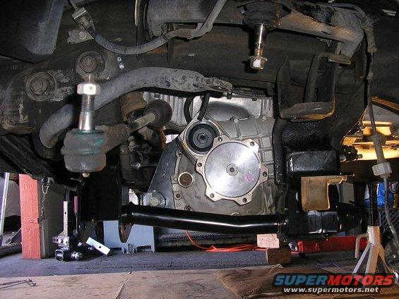 Underside view of vehicle's front suspension and part of the drivetrain