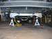 1979 Chevrolet C/K Pickup - The underside of a vehicle is elevated on jack stands for maintenance.