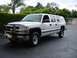 1979 Chevrolet C/K Pickup - This white pickup truck features a chrome grille guard and a matching cap over the bed.
