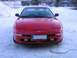 1994 Ford Probe - Front view of a red coupe parked in the snow, pop-up headlights and a Finnish license plate.