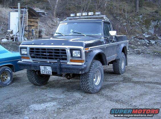 1979 Ford Bronco parked on dirt, front quarter view. Another vehicle is partially visible to the left