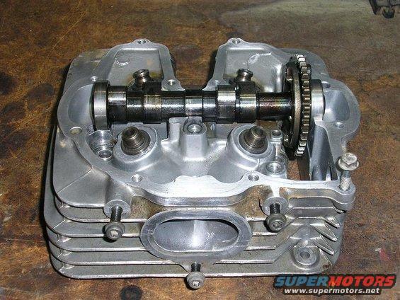 Motorcycle engine cylinder head with camshaft and valves visible