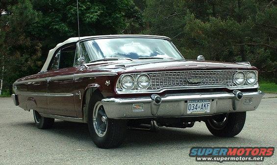 Maroon 1963 Ford Galaxie convertible with white top, front grille detail