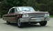 1963 Ford Galaxie - A maroon 1963 Ford Galaxie convertible is shown from a three-quarter front view, highlighting its distinctive grille and chrome details.