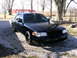 2001 Ford Crown Victoria - 2001 Ford Crown Victoria with a blacked-out grille and aftermarket wheels.
