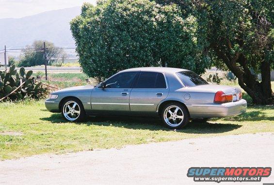 Silver 2000 Mercury Grand Marquis sedan, side view