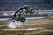 1976 Ford F-150 - Monster truck performing a jump at an indoor event with "Monster Jam" signage visible.