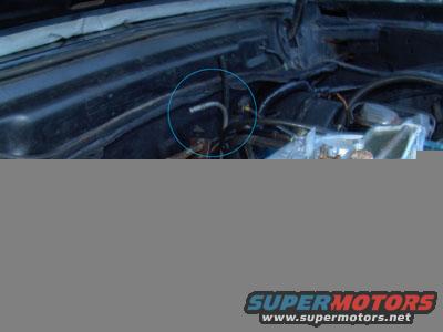 Close-up of a car's engine bay with various hoses and components visible