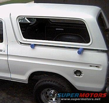 1978 Ford Bronco side view, white with aftermarket hardtop, blue securing straps on roof rail