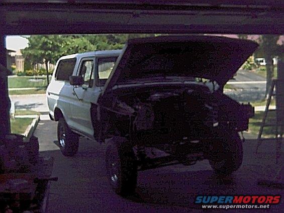 Ford Bronco with hood open, parked in garage