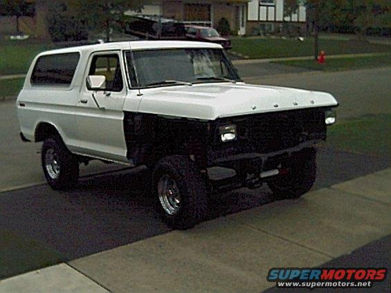 1978 Ford Bronco, white, missing front grille, parked on driveway