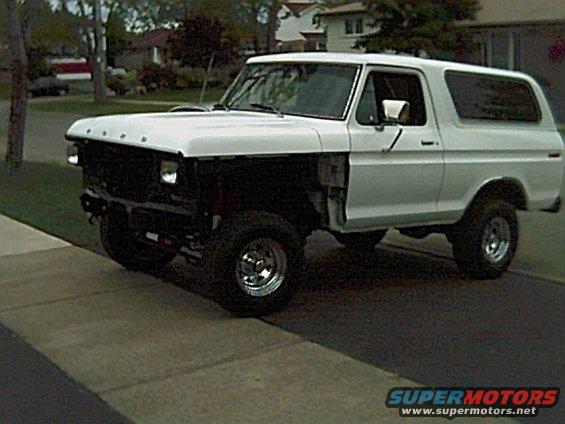 White 1978 Ford Bronco parked on a driveway, front fenders removed