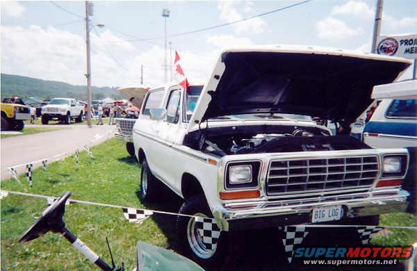 1978 Ford Bronco with hood open, parked at an outdoor event. License plate reads BIG LOG