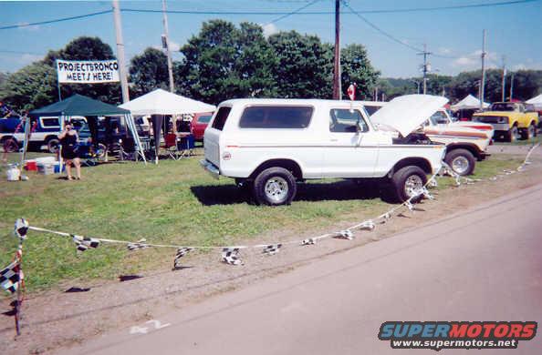 White 1978 Ford Bronco parked at an outdoor event with a "Project Bronco Meets Here" sign
