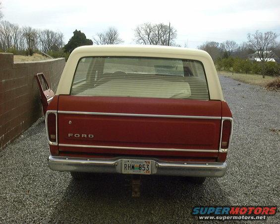 Rear view of a 1978 Ford Bronco, red with white top. License plate reads RHM 853