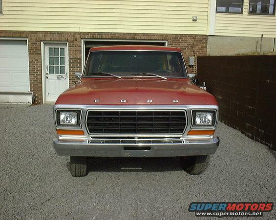 Red 1978 Ford Bronco front view with chrome grille and orange turn signals