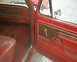 1978 Ford Bronco - Interior view of a red 1978 Ford Bronco, showing door panel and seat details.