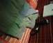1978 Ford Bronco - A green jacket and a flashlight are placed on a striped blanket or rug.