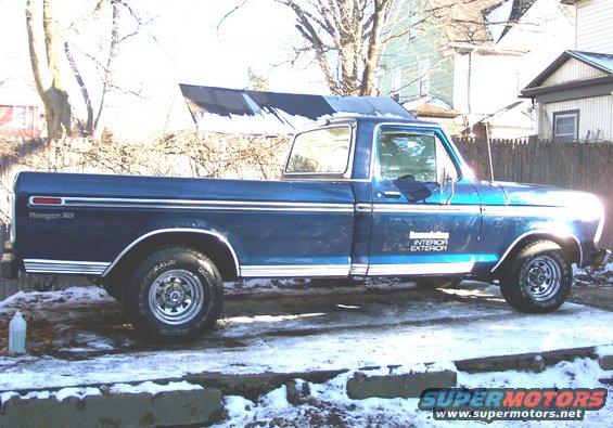 Blue pickup truck, side view. Has 'Ranger XLT' on the fender and 'INTERIOR EXTERIOR' on the door