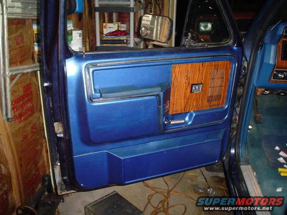 1984 Ford Bronco interior door panel with blue vinyl and wood grain trim