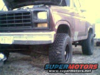 Front view of a maroon 1981 Ford Bronco with the hood up. It has large tires and a chrome bumper