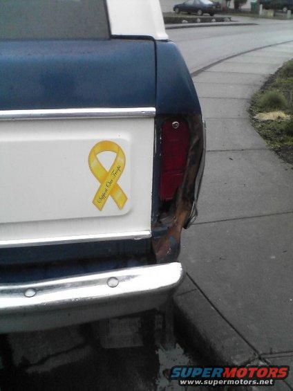 1978 Ford Bronco rear corner with damaged taillight and yellow ribbon sticker