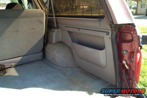 1996 Ford Bronco interior cargo area with grey carpet and side panel storage