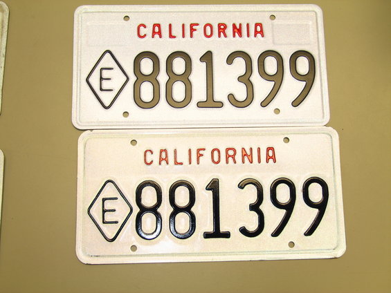 Two California license plates with the number 881399 and a diamond shape with an E inside