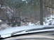 1993 Ford Bronco - Two off-road vehicles navigate a rocky, snow-dusted path through a forest.