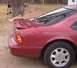 1994 Ford Thunderbird - Rear view of a red 1994 Ford Thunderbird coupe with a spoiler.