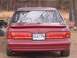 1994 Ford Thunderbird - The rear of a red Ford Thunderbird is shown, its distinctive taillight design and a license plate.