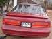 1994 Ford Thunderbird - Rear view of a red 1994 Ford Thunderbird, showing its distinctive taillights and spoiler.