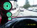 1994 Ford Probe - Interior view of a car's dashboard with gauges, overlooking a residential street scene with parked vehicles.