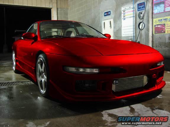 Red 1994 Ford Probe with aftermarket intercooler parked indoors