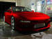1994 Ford Probe - A red 1994 Ford Probe is shown from the front-three-quarter view, possibly at a car wash.