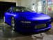 1994 Ford Probe - A bright blue sports coupe is parked in a car wash bay, showing off its custom front bumper and intercooler.