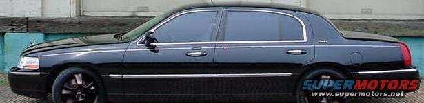 Side view of black sedan with tinted windows and chrome trim