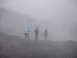 1979 Ford Bronco - Three individuals are visible on a desolate, foggy hillside, with visibility severely limited by the weather conditions.