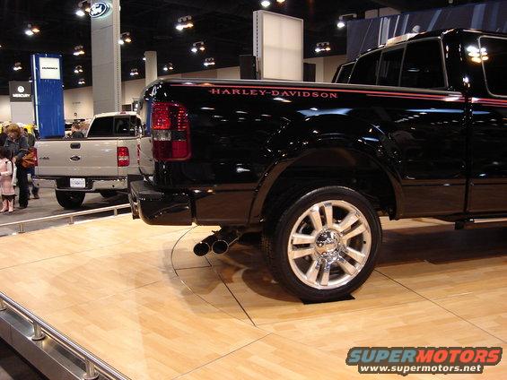 Black pickup truck rear view with Harley-Davidson badging and dual exhaust