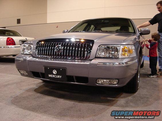Silver Mercury Grand Marquis with chrome grille and Mercury badge, front view