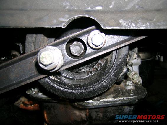 Pulley assembly with bolts and engine components visible