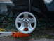 1994 Jeep YJ - A Jeep YJ wheel is shown on a jack, with the vehicle's frame and suspension visible.