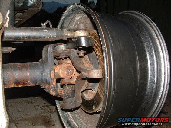 Close-up of a Jeep's front axle, U-joint, and wheel assembly
