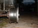 1994 Jeep YJ - Close-up of a Jeep YJ wheel and axle assembly, with part of the vehicle body visible.