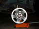 1994 Jeep YJ - A vehicle's wheel and suspension are visible, with an orange jack supporting the frame.