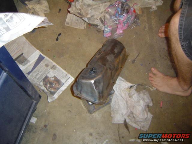 metal valve cover on concrete floor with newspapers and rags