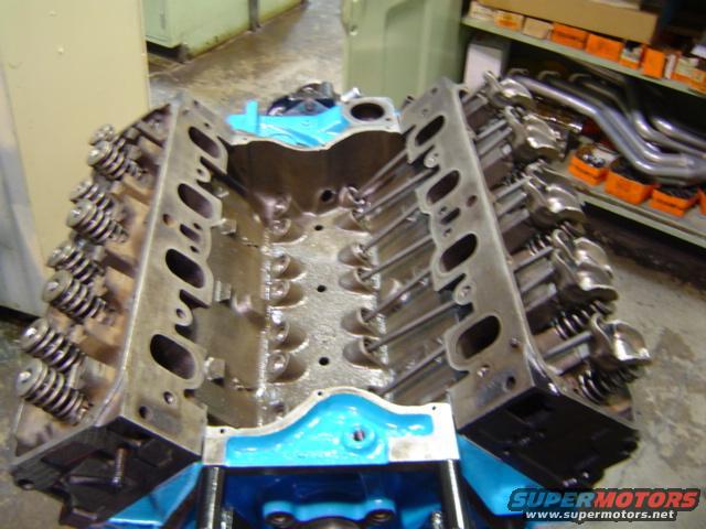 Engine block with valve springs and exhaust manifolds on shelf